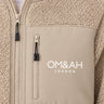 Close-up of the Om & Ah London logo on the Desert Signature Sherpa