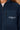 Close-up of the Om & Ah London logo on the French Navy Signature Sherpa